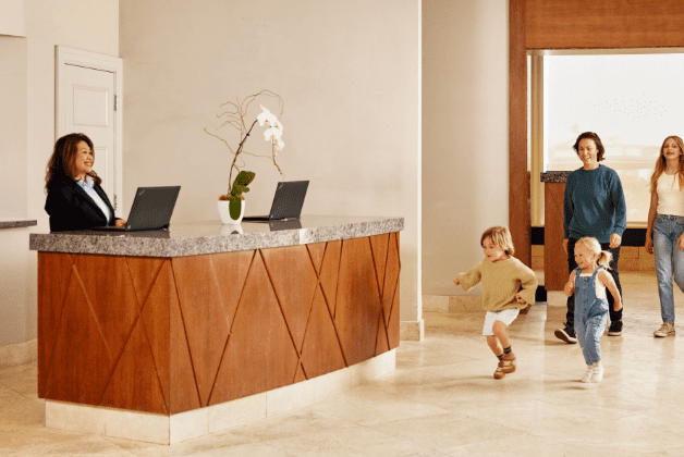 Family walking up to a hotel front desk